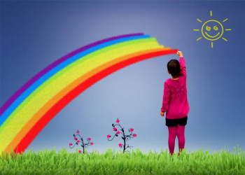 Little girl painting a rainbow on the sky