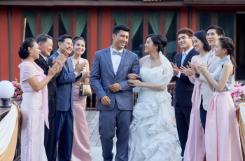 newlyweds are walking with arm in arm and guests are clapping