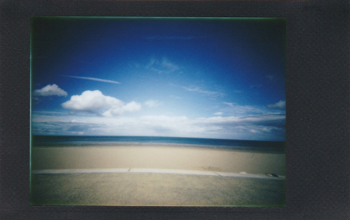 analog,beach,blue sky,clouds,film photography,horizon,instant film,ocean,outdoors,polaroid,sand,sea,seashore,shore,summer,travel,water