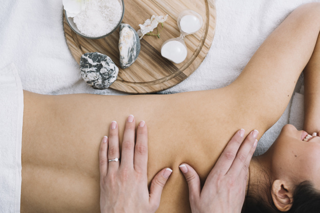 masseuse,therapeutic,receiving,relaxed,relaxing,relaxation,treatment,calm,hygiene,stones,therapy,top view,top,towel,zen,view,wellness,care,relax,salon,stone,healthy,natural,massage,body,beauty salon,health,spa,beauty,nature,woman