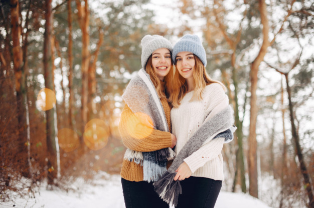 outside,cheerful,sisters,casual,two,wear,twins,pretty,frost,positive,season,lifestyle,portrait,beautiful,sweater,scarf,young,female,outdoor,youth,cold,frozen,girls,model,weather,gray,fun,clothing,park,hat,person,yellow,white,women,holiday,happy,smile,face,cute,beauty,nature,fashion,hand,snow,people,winter,christmas