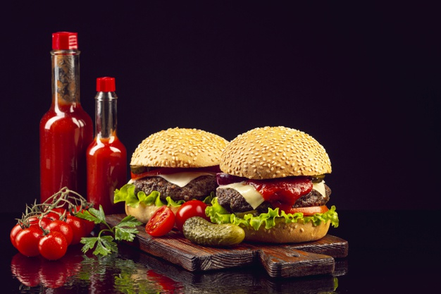 ketchup bottle,slice,grilled,pickle,ingredient,cutting,sesame,tasty,front,bun,burgers,tomatoes,horizontal,reflection,ketchup,delicious,lettuce,fastfood,american,gourmet,onion,view,beef,fresh,classic,tomato,hamburger,salad,sandwich,bbq,meat,organic,burger,bottle,board,vegetables,black,black background,restaurant,leaf,food,background