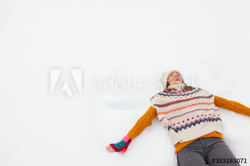 carefree,woman,adult,young,constructed,angel,smile,happiness,enjoy,front view,lay,lifestyle,travel,snow,cold,winter,play,playful,vitality,sweater,warm clothes,fun,youth culture,beautiful,vacation,freedom,well-being,outdoors,day,people,1,alone,copy space,adobestock